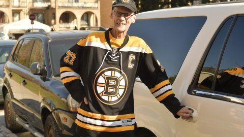 Richard in Bruins uniform is posing before he ride on a car.